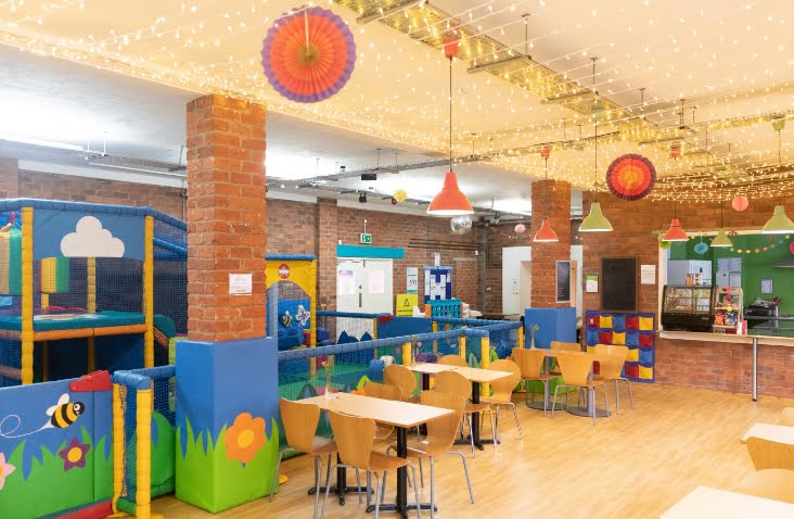Our large soft play and cafe area with tables and chairs